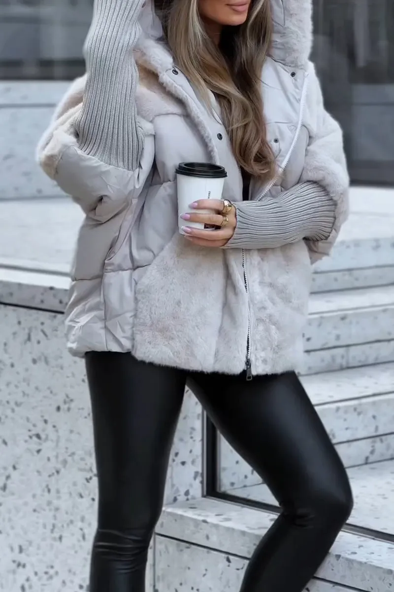Light gray hooded puffer jacket with plush fur panels, ribbed sleeves, and a front zipper, shown with a takeaway cup.