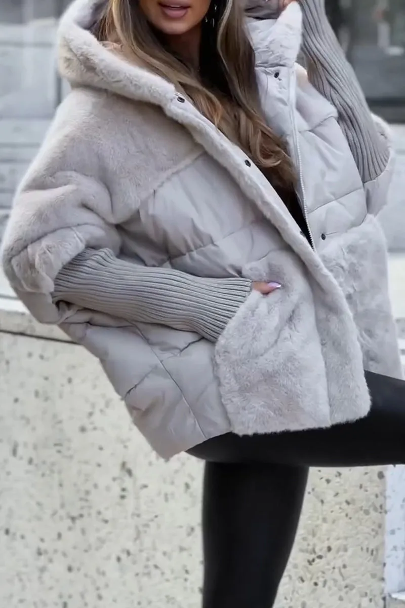 Cream jacket detail highlighting the generous hood, mixed plush and quilted textures, and extended ribbed cuffs.