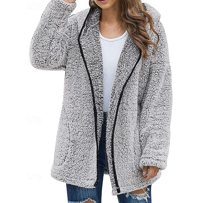 Light gray hooded teddy jacket styled open over a white top, with black trim and distressed jeans.
