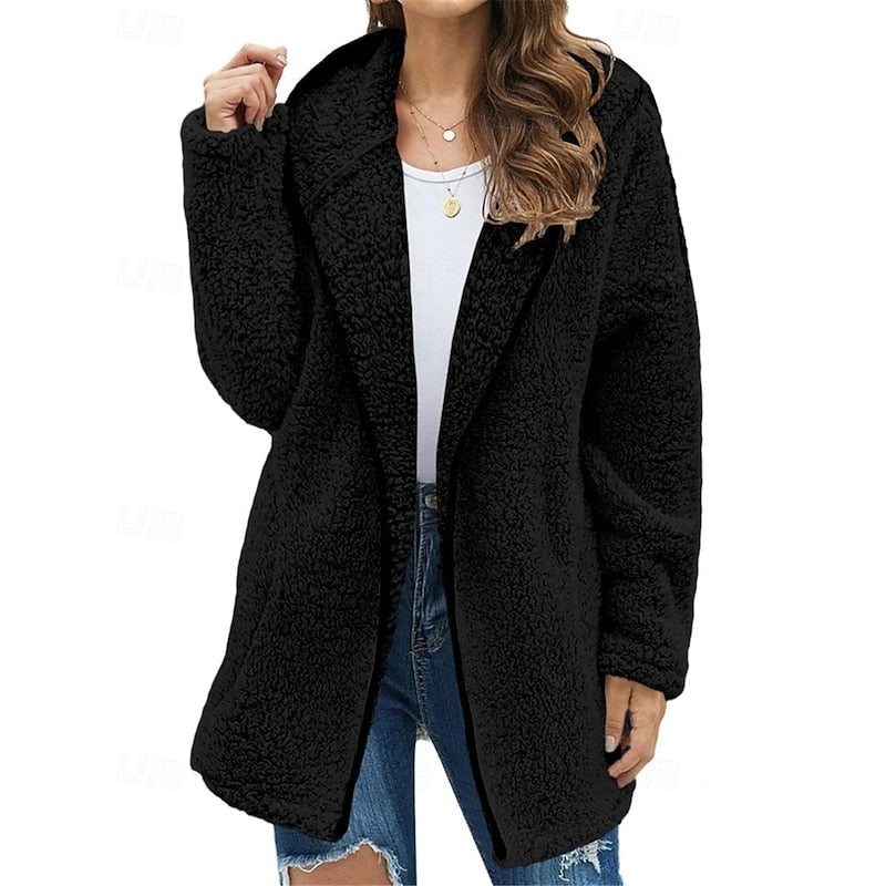 Black plush teddy jacket with a hood, open front, long relaxed shape, and subtle dark trim.