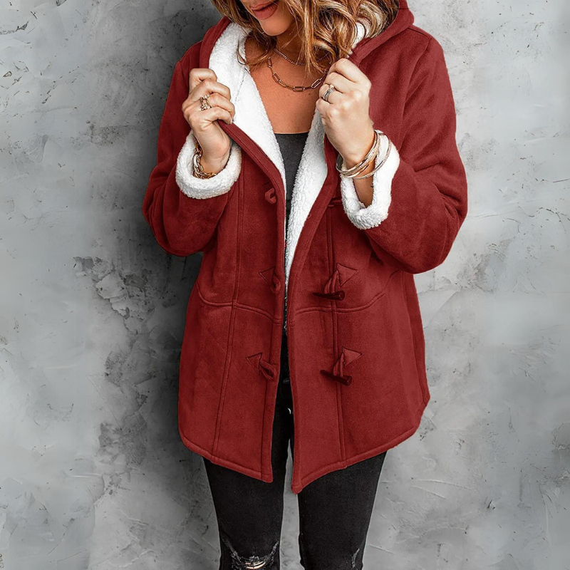 Red hooded toggle coat with a soft white lining, front pockets, and the front held open over black clothing.