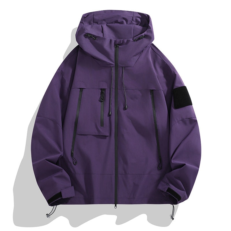 Purple utility jacket featuring a hood with drawcords, full zip front, several zip pockets, sleeve patch, and cinched hem details.