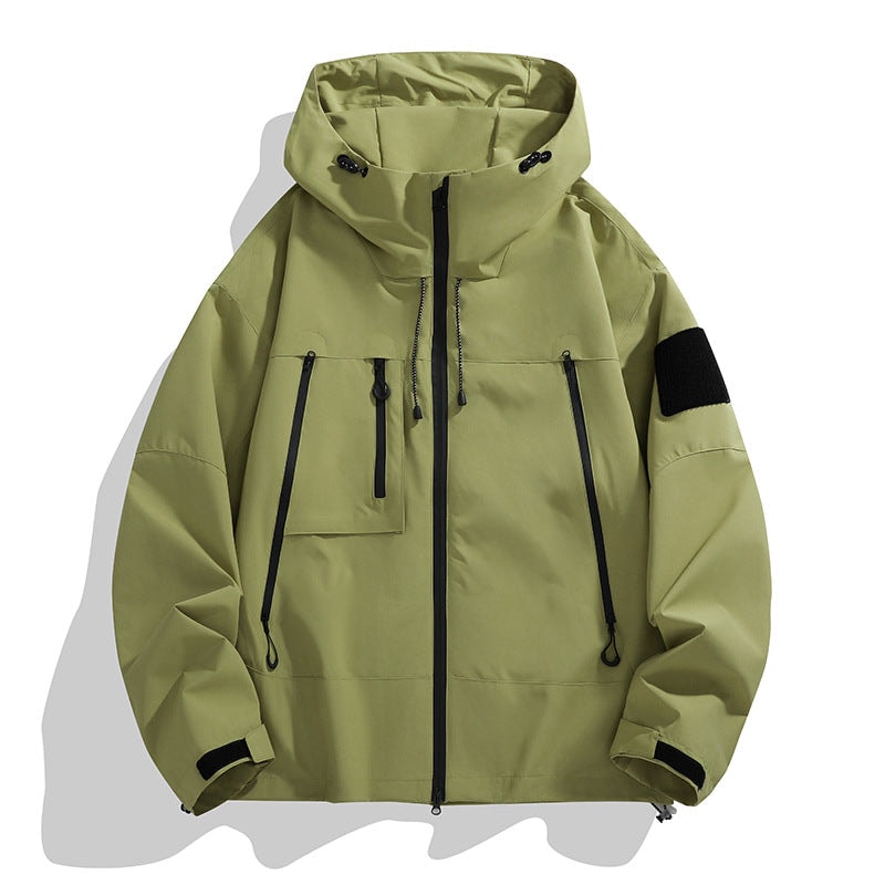 Olive green hooded jacket with a full-length zipper, contrasting black pocket zippers, flap pocket, sleeve patch, and adjustable cuffs.