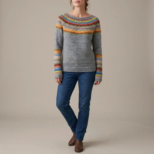 Woman wearing a long sleeve knit jumper with a patterned fair isle yoke and cuffs, boat neckline and ribbed hem, with straight jeans and ankle boots._0
