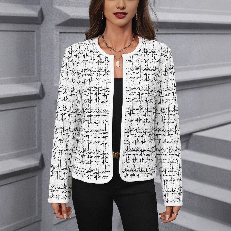 White jacket with a black contrast check pattern and rounded front edges, worn open over a black top with black trousers.