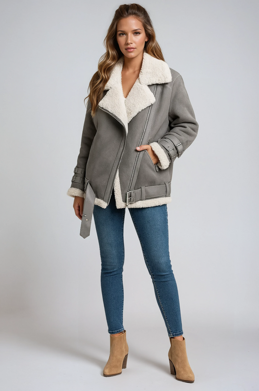 Gray jacket with an oversized plush collar, asymmetric zip front, and side buckle detail, styled with blue jeans and tan ankle boots.