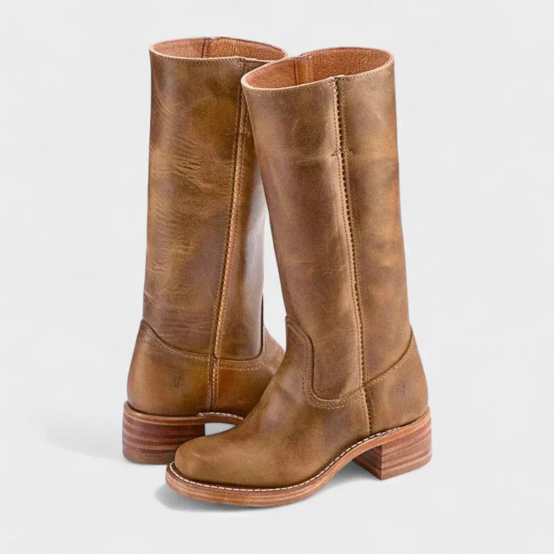 Tan knee-high boots with stitched panel detailing, rounded toes, and layered stacked heels shown in a three-quarter view.