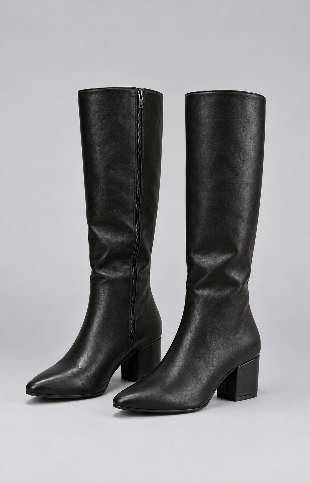 Pair of black knee-high boots with pointed toes, clean shafts, and sturdy block heels shown together.