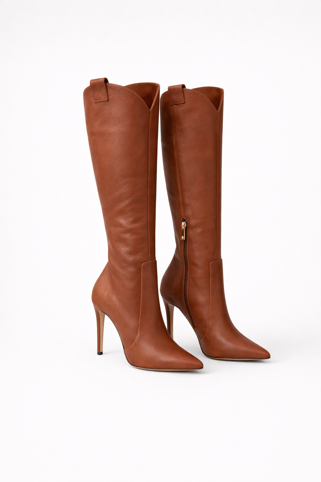 Brown knee-high pointed-toe boots with tall stiletto heels, including a visible side zipper on the rear boot.