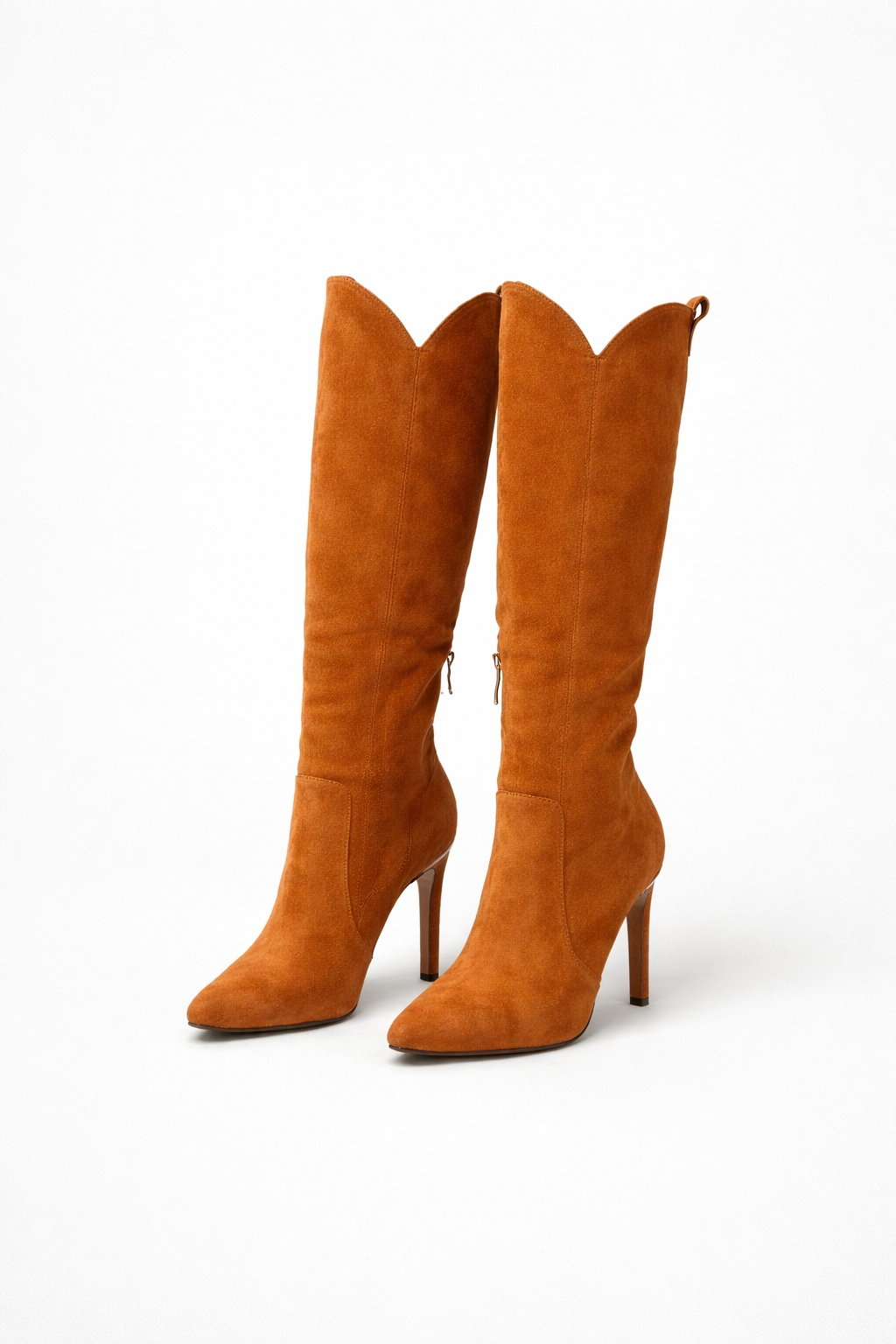 Warm tan knee-high boots displayed from the back, showing sculpted shafts, pointed toes, and slim stiletto heels.