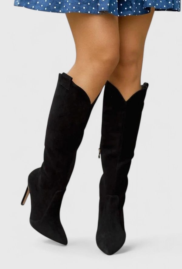 Pair of black knee-high pointed-toe boots shown from the front, with slim heels and angled shaft openings.
