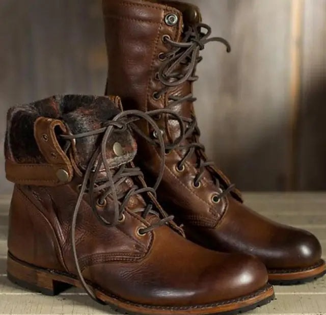 Pair of brown lace-up ankle boots with round toes, padded collars, and rugged-looking soles shown from a front three-quarter angle.
