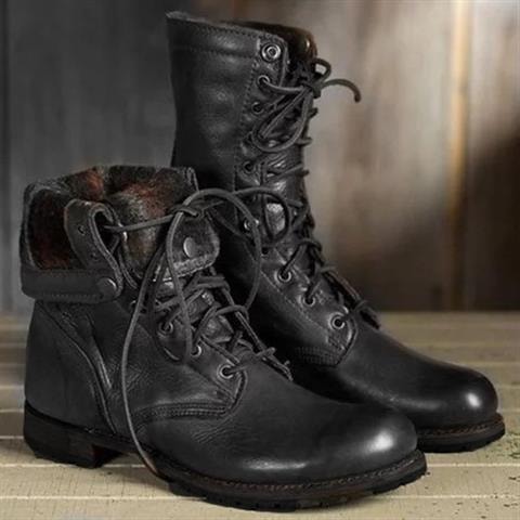 Black lace-up ankle boots with round toes and rugged soles shown from a front three-quarter view, with one boot overlapping the other.
