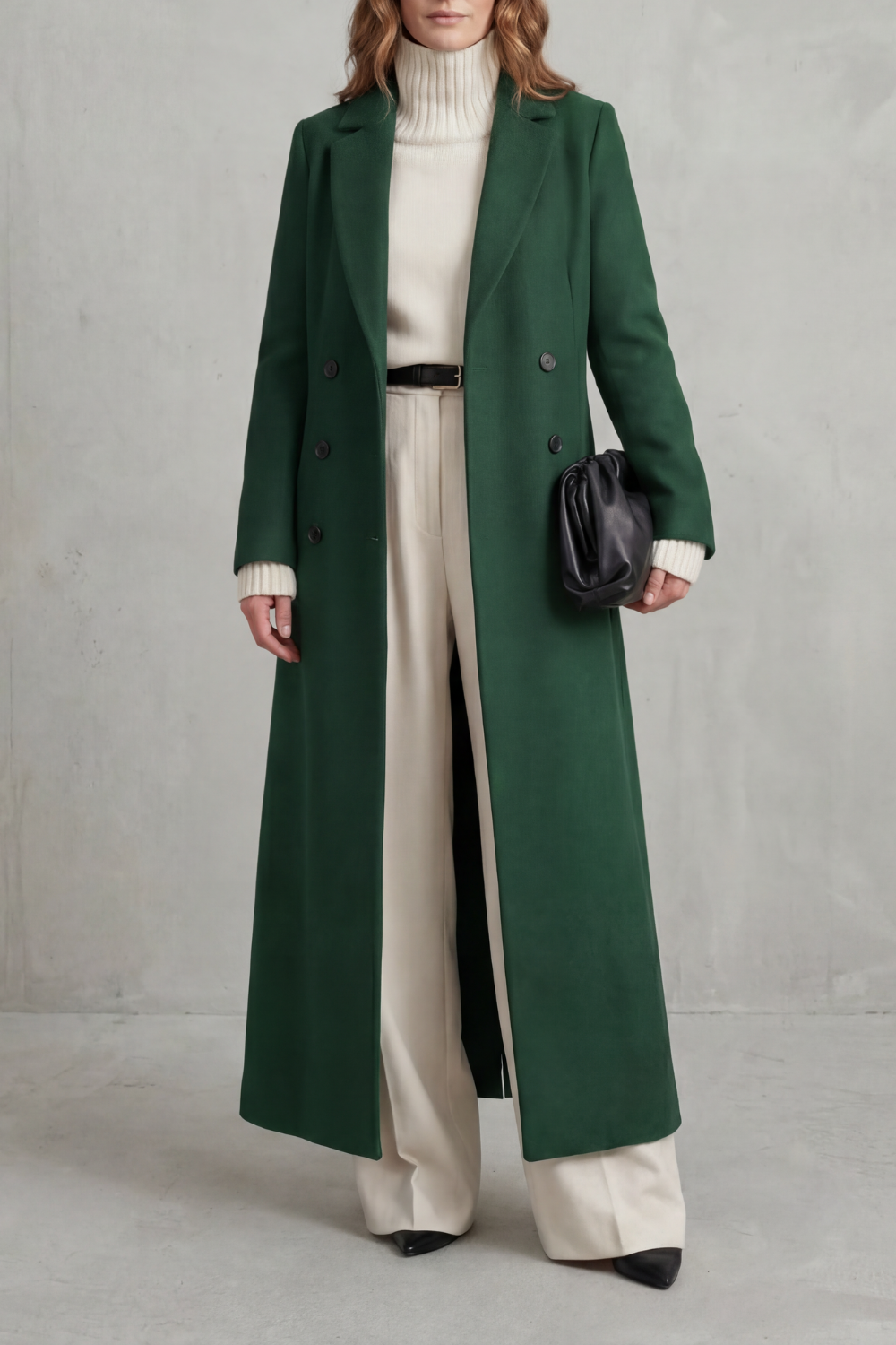 Front view of a dark green long coat with a structured notched lapel collar, long sleeves and double-breasted buttons.