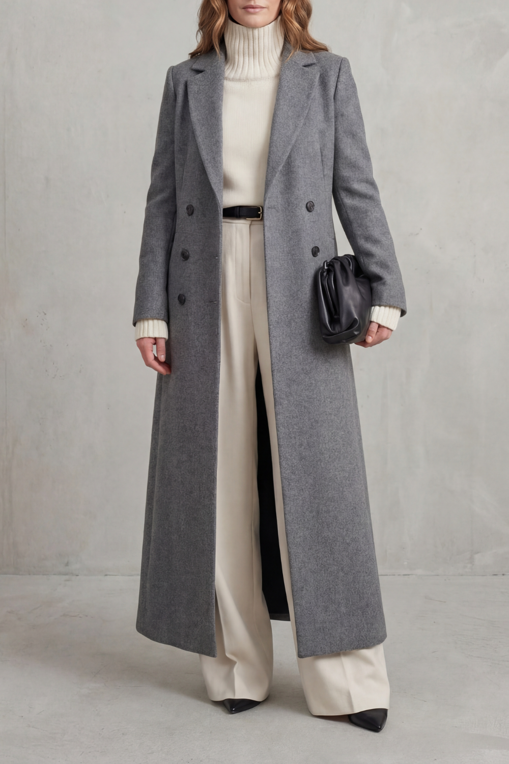 Front view of a gray long tailored coat featuring notched lapels, long sleeves and two rows of dark buttons.