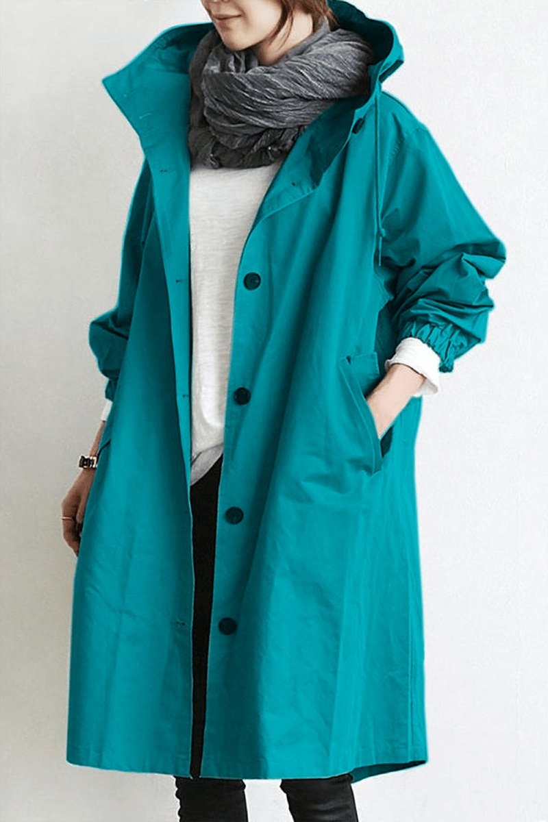 Turquoise long hooded coat shown from the front with a button closure, drawstring hood, side pockets, and scrunched adjustable cuffs.