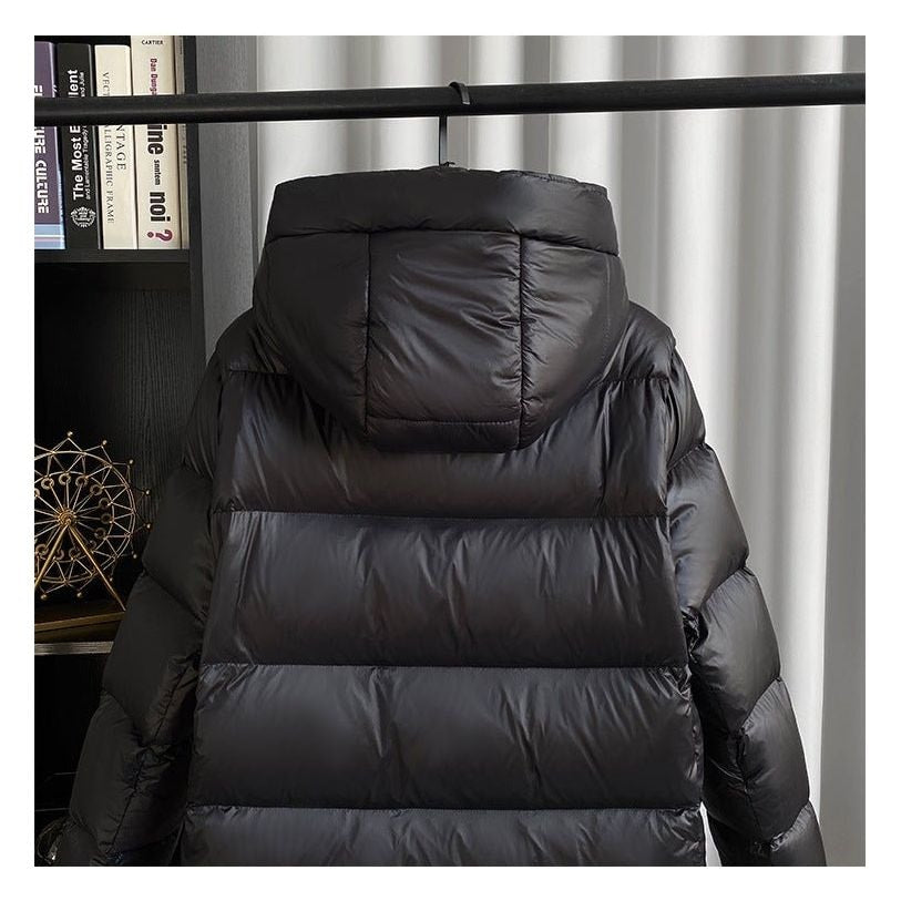 Back view highlighting the oversized hood and horizontal quilting across the long jacket.