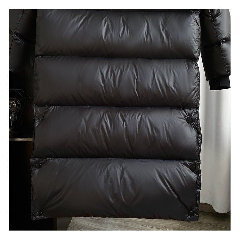 Close-up of the jacket’s lower back with horizontal quilted sections and snap fasteners at the sides.