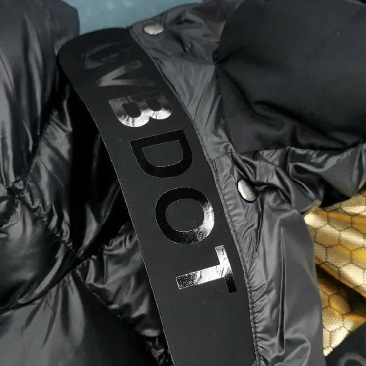 Close-up of the jacket’s black branded neck label and snap fastening near the hood.
