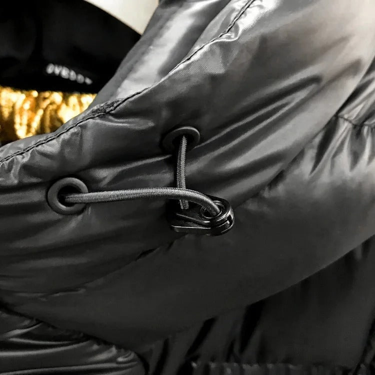 Close-up of an adjustable drawcord and toggle on the black quilted jacket.