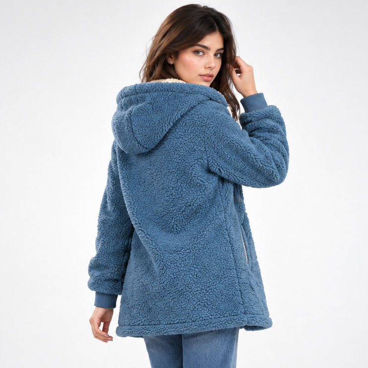 Back view showing the blue teddy jacket’s hood, textured long body, sleeves, and straight hem.