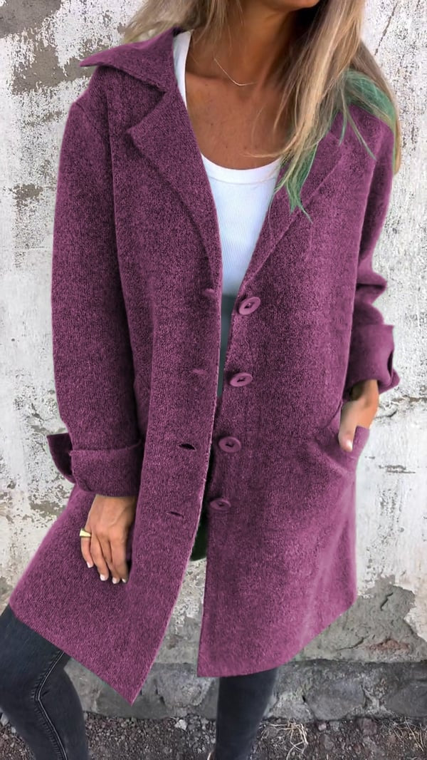 Purple longline blazer jacket worn over a white top, with a row of front buttons and rolled sleeve cuffs.