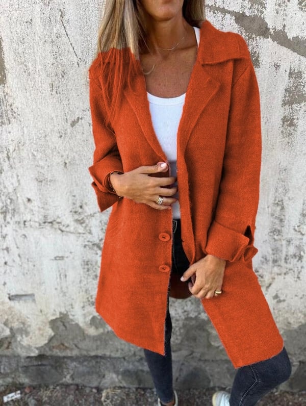 Orange longline button-front blazer jacket shown from a slightly angled front view with notched lapels and turned-back cuffs.