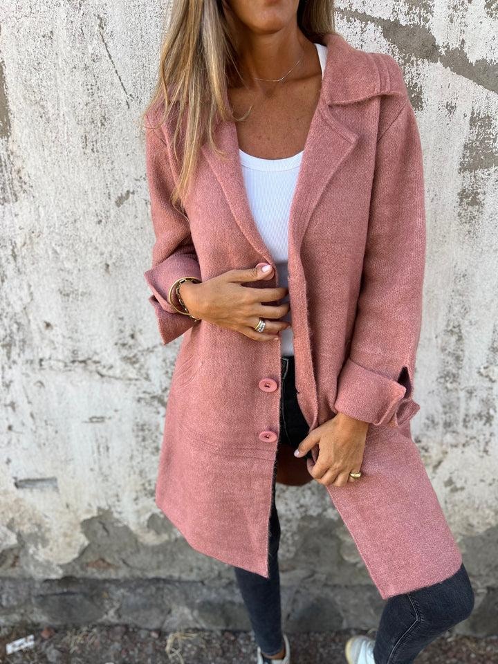 Front view of the pink longline blazer jacket showing its button fastening, extended hem, and notched lapels.
