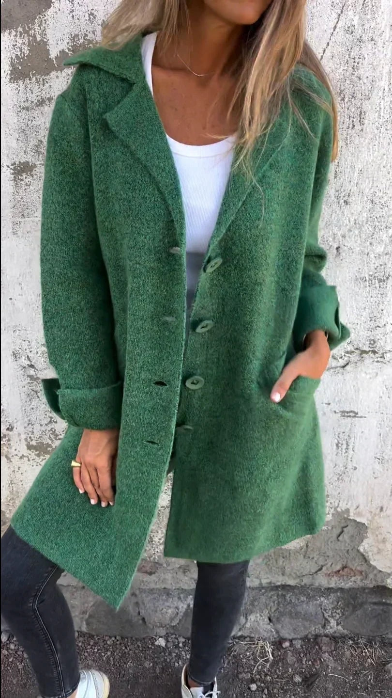 Green longline button-front blazer jacket with notched lapels, rolled cuffs, and front pockets.