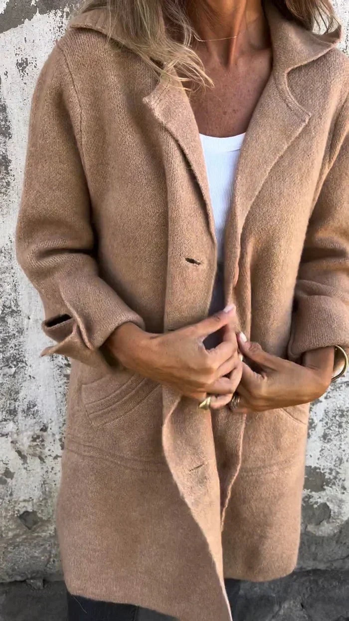 Camel brown blazer jacket shown close up with notched lapels, button front, and flap-style front pockets.