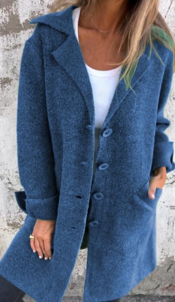 Blue longline blazer jacket with notched lapels, visible buttons, and rolled cuffs shown from the front.