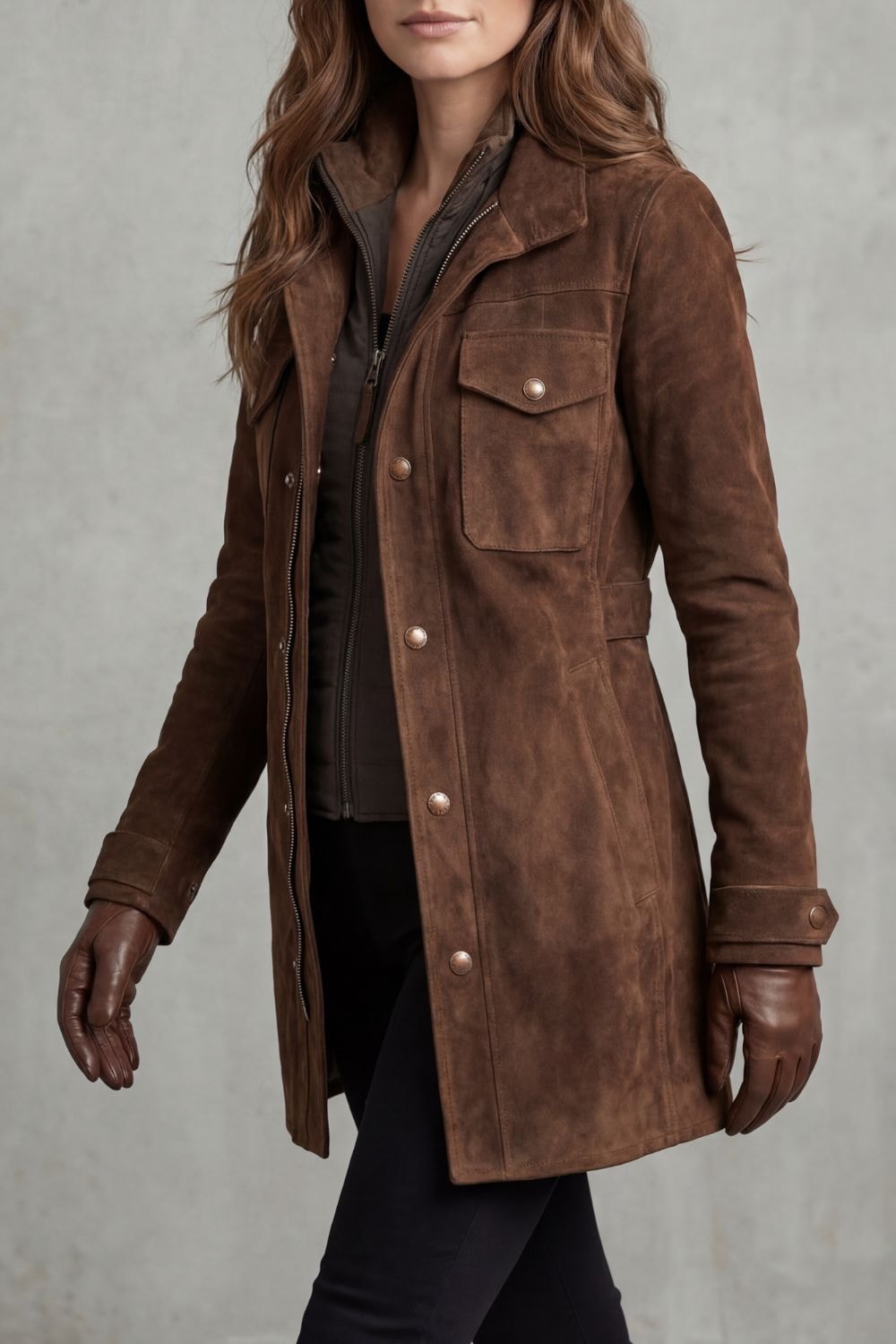 Three-quarter view of the brown suede-look coat highlighting its longline silhouette, raised collar, front closure, and flap chest pocket.