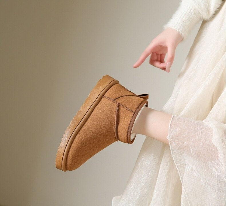 Tan low ankle snow boot shown in side view with stitched panels, a thick platform sole, and a pull-on opening.