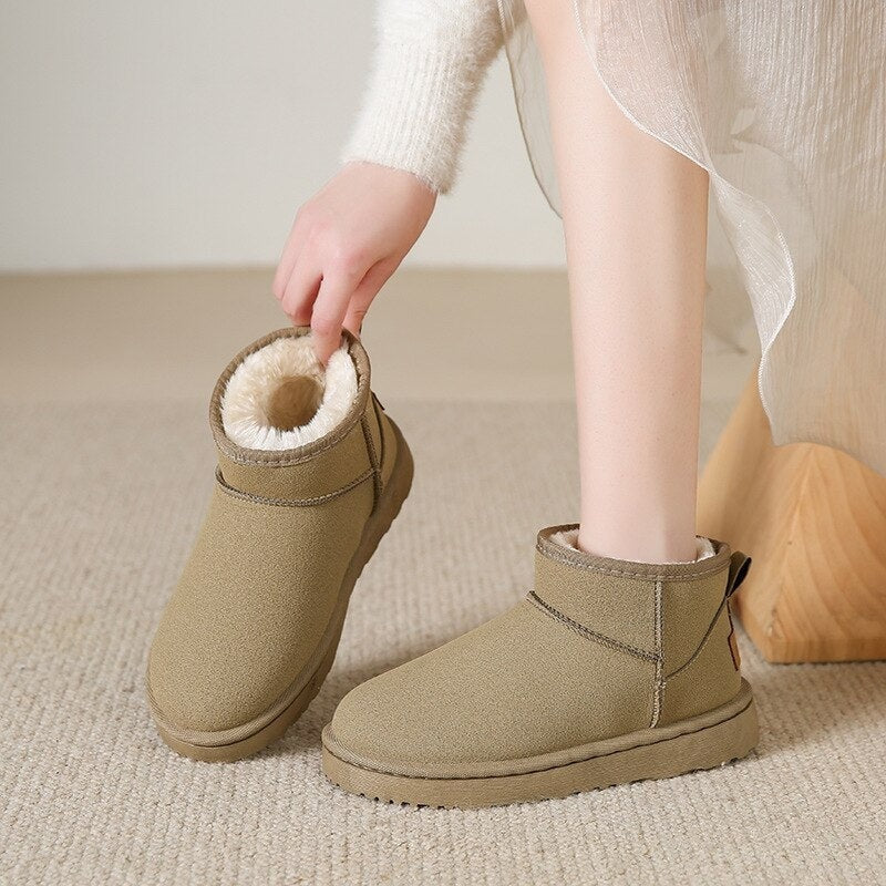 Taupe low ankle snow boots being worn and held, showing the rounded toes, plush lining, and thick platform soles.
