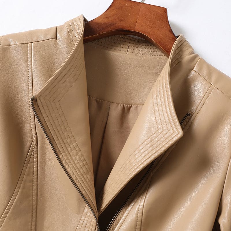 A women's moto-style jacket with a structured collar and asymmetrical front zip displayed on a wooden hanger._6
