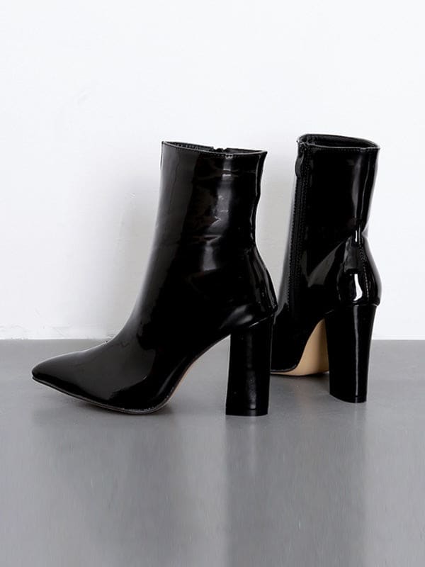 Metallic silver ankle boots with pointed toe and block heel worn with cropped jeans on a neutral surface_16