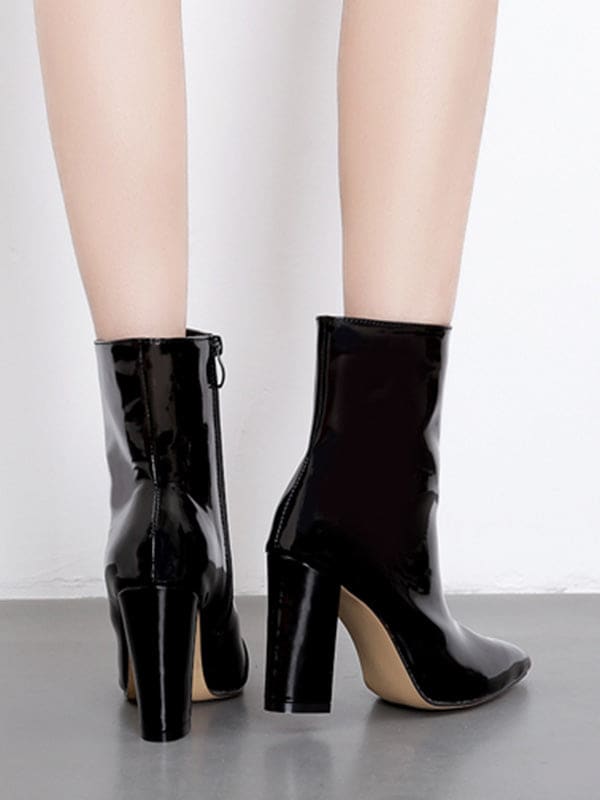 Metallic silver ankle boots with pointed toe and block heel worn with cropped jeans on a neutral surface_2