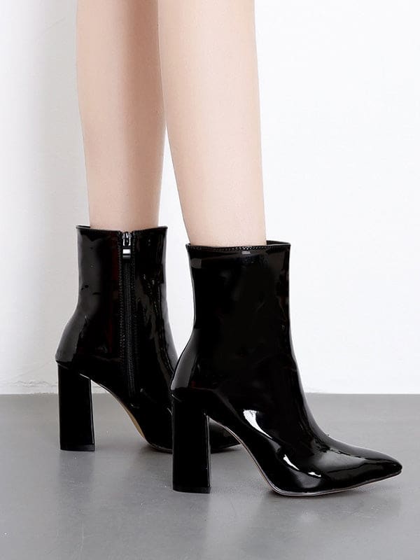 Metallic silver ankle boots with pointed toe and block heel worn with cropped jeans on a neutral surface_3