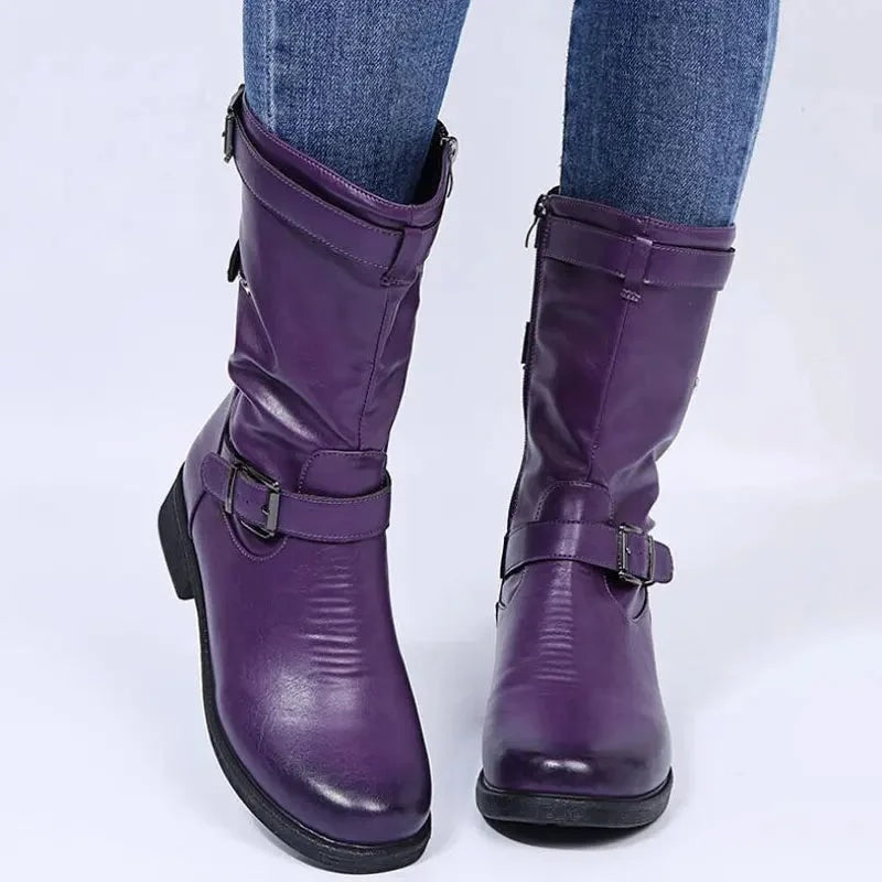 Front view of purple mid-calf boots showing the rounded toes, low block heels, and buckle straps across the lower shafts.