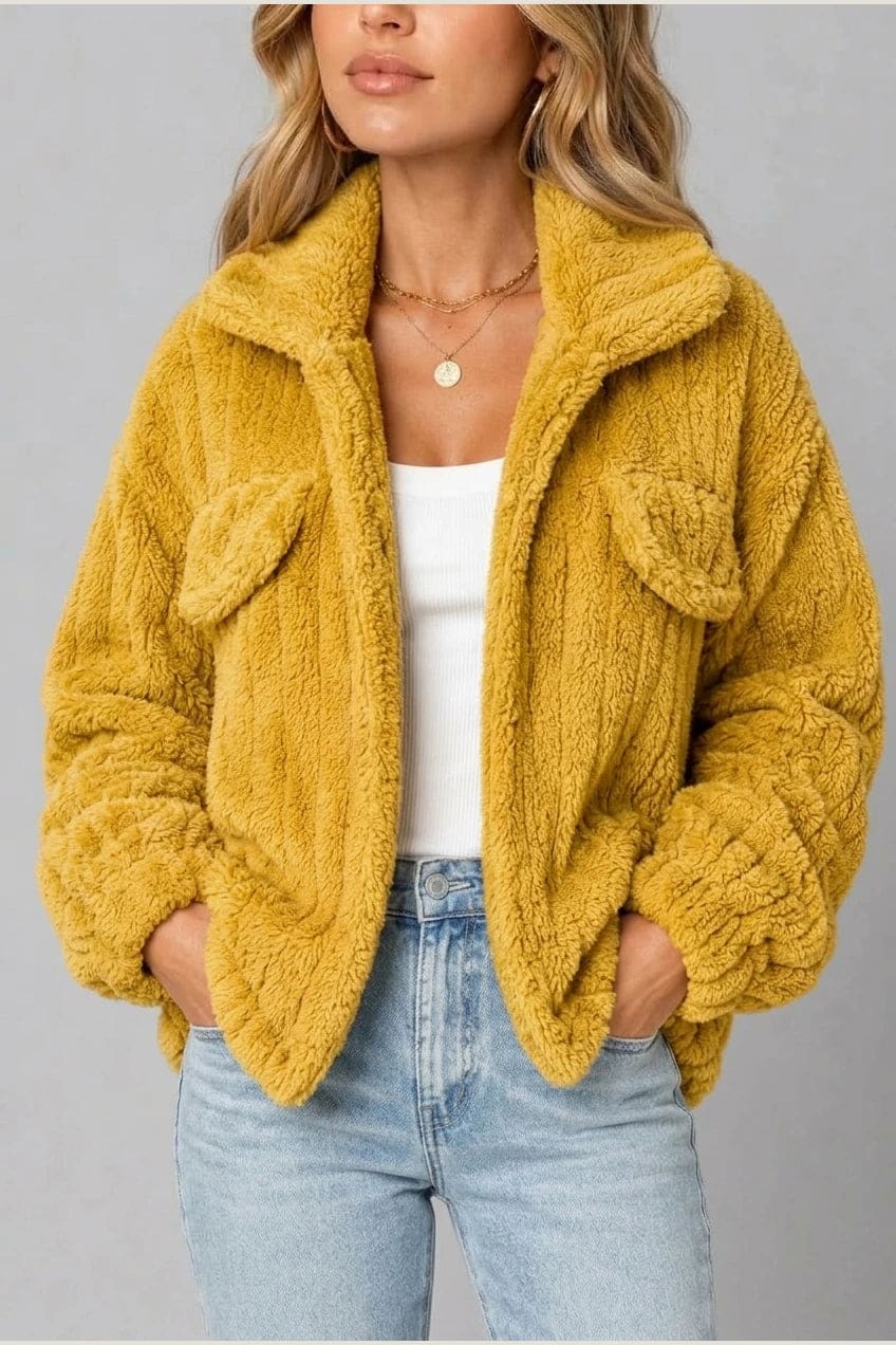 Cropped textured fleece jacket with wide collar, open front, chest flap pockets and elasticated cuffs, worn over a tank top with straight leg jeans and white trainers._10