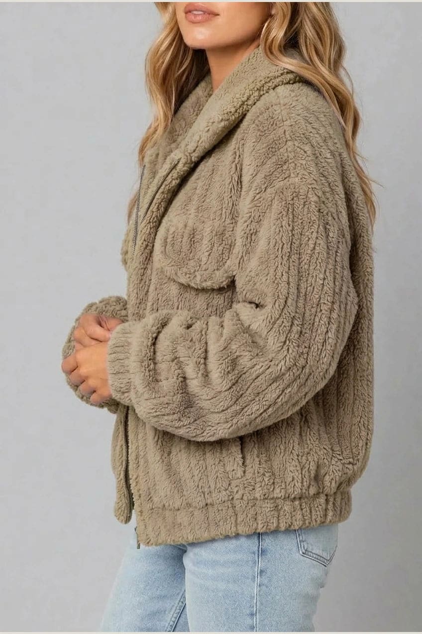 Cropped textured fleece jacket with wide collar, open front, chest flap pockets and elasticated cuffs, worn over a tank top with straight leg jeans and white trainers._13