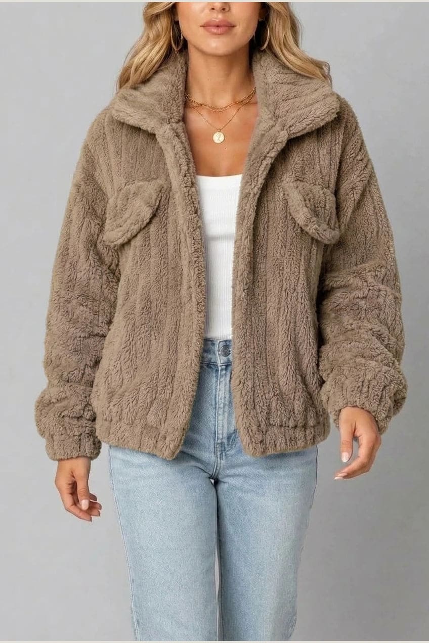 Cropped textured fleece jacket with wide collar, open front, chest flap pockets and elasticated cuffs, worn over a tank top with straight leg jeans and white trainers._14