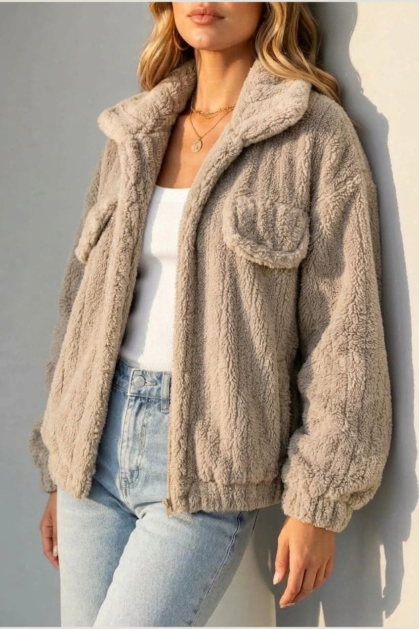 Cropped textured fleece jacket with wide collar, open front, chest flap pockets and elasticated cuffs, worn over a tank top with straight leg jeans and white trainers._15