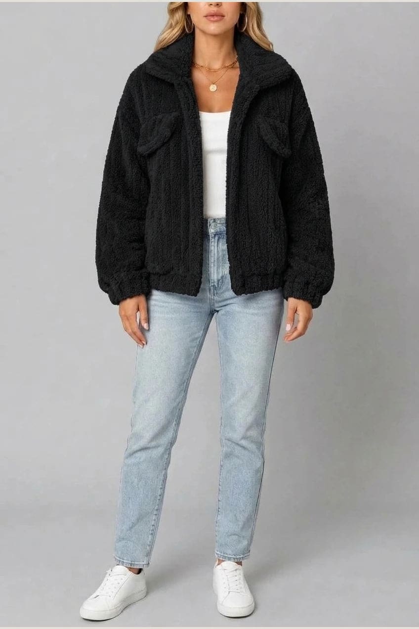 Cropped textured fleece jacket with wide collar, open front, chest flap pockets and elasticated cuffs, worn over a tank top with straight leg jeans and white trainers._18