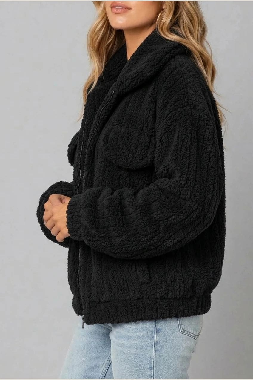 Cropped textured fleece jacket with wide collar, open front, chest flap pockets and elasticated cuffs, worn over a tank top with straight leg jeans and white trainers._19