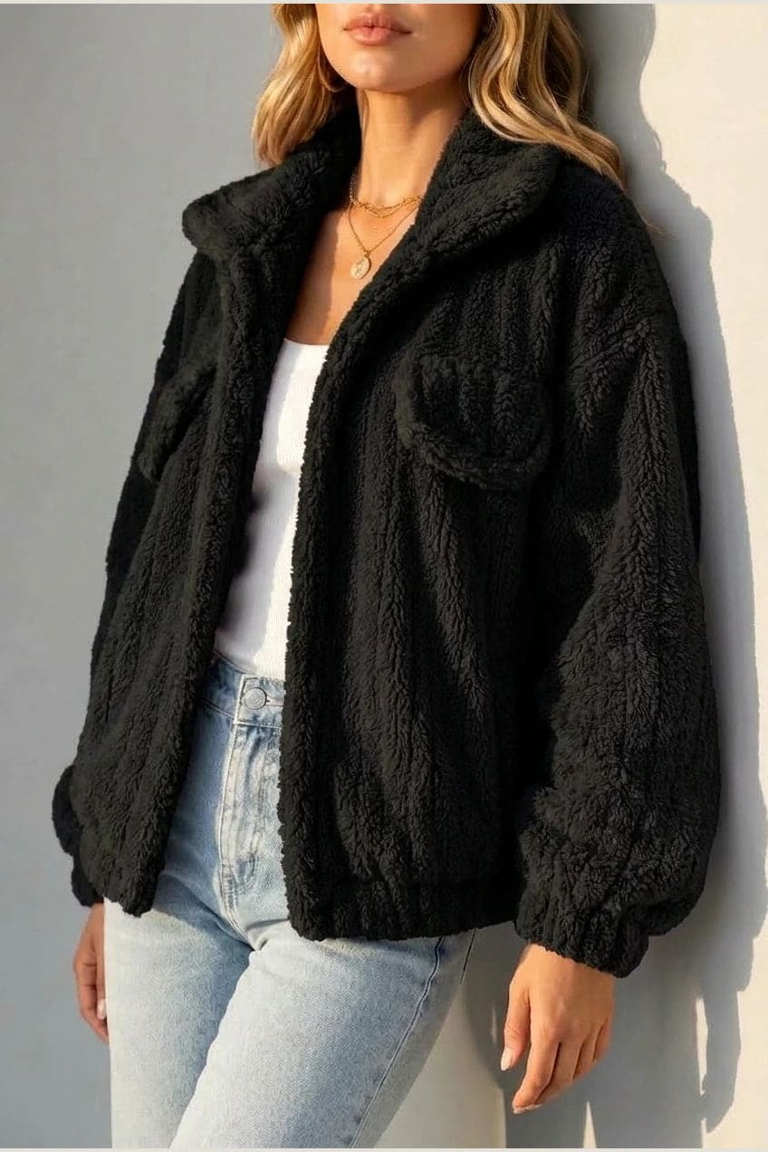 Cropped textured fleece jacket with wide collar, open front, chest flap pockets and elasticated cuffs, worn over a tank top with straight leg jeans and white trainers._21