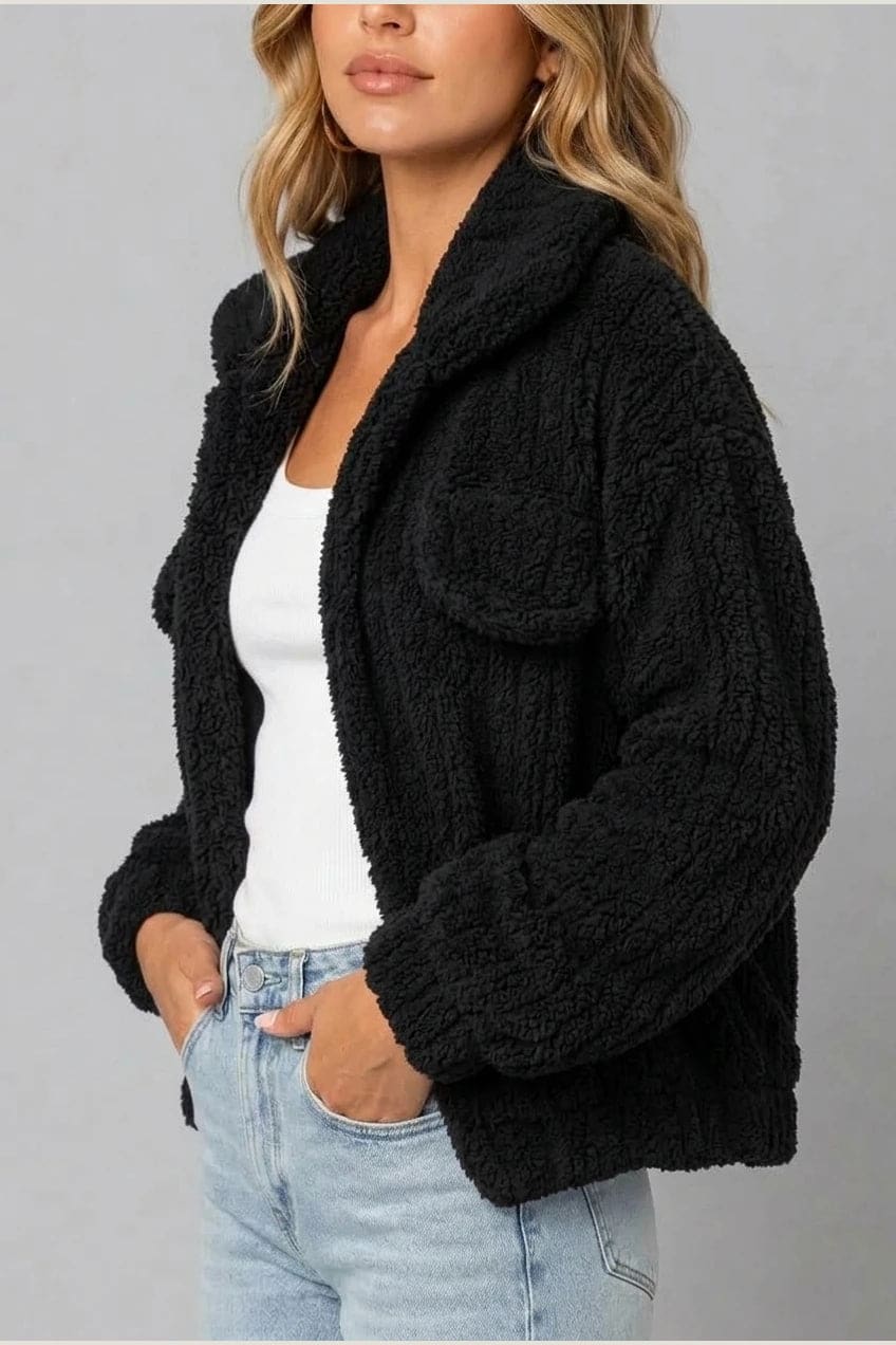 Cropped textured fleece jacket with wide collar, open front, chest flap pockets and elasticated cuffs, worn over a tank top with straight leg jeans and white trainers._22