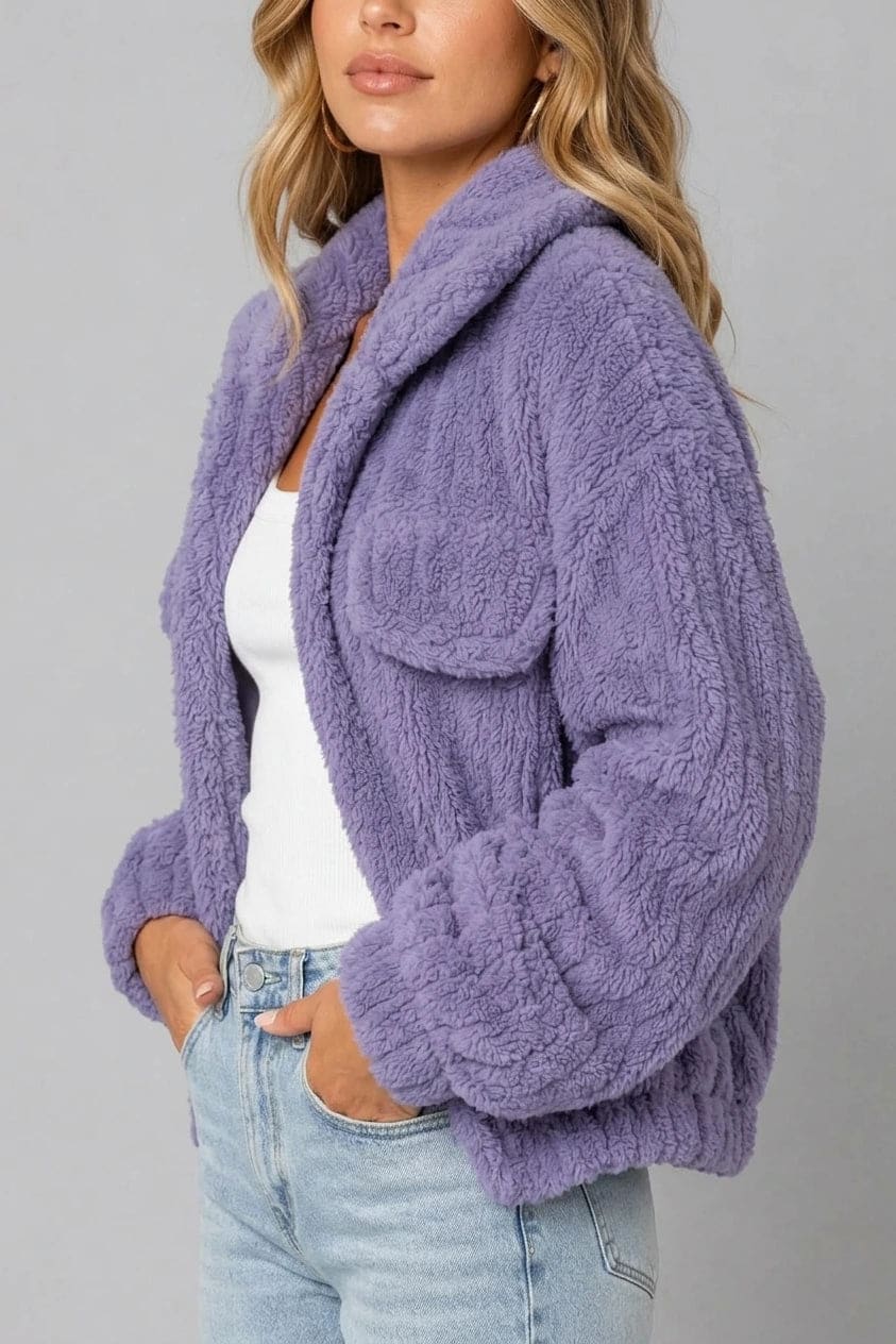 Cropped textured fleece jacket with wide collar, open front, chest flap pockets and elasticated cuffs, worn over a tank top with straight leg jeans and white trainers._4