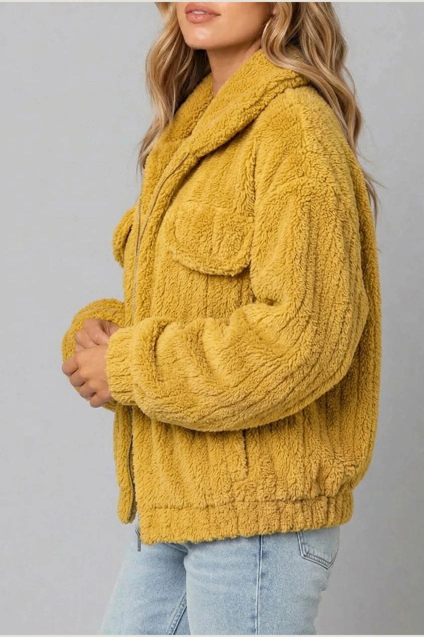 Cropped textured fleece jacket with wide collar, open front, chest flap pockets and elasticated cuffs, worn over a tank top with straight leg jeans and white trainers._7