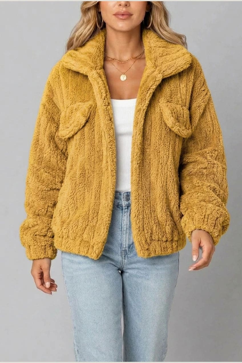Cropped textured fleece jacket with wide collar, open front, chest flap pockets and elasticated cuffs, worn over a tank top with straight leg jeans and white trainers._8